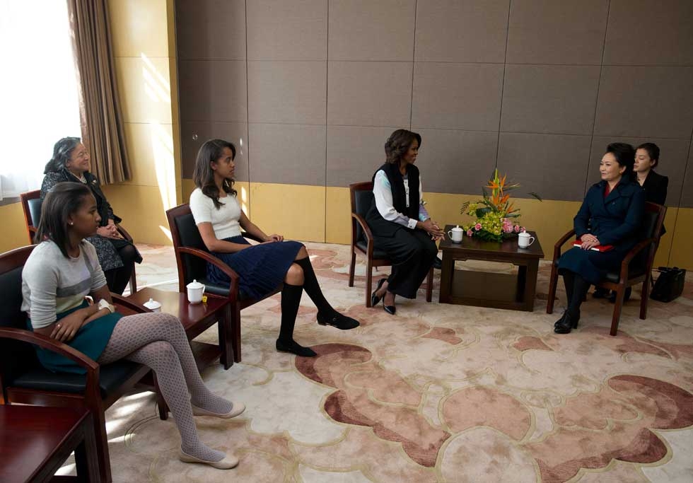 Michelle Obama (C), her daughters Sasha (L) and Malia (2nd L) meet with Peng Liyuan, wife of Chinese President Xi Jinping, on a visit the Beijing Normal School, which prepares students to attend university abroad, in Beijing on March 21, 2014. (Andy Wong-Pool/Getty Images) 