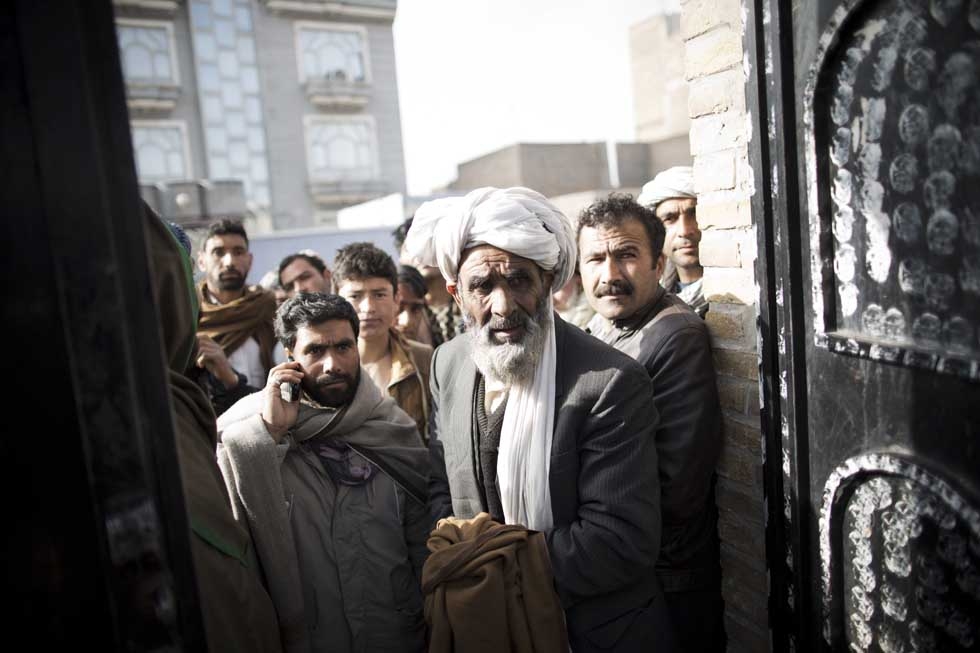 Afghans gather outside a closed voter registration center to try to receive their voter cards a day after registration ended for the forthcoming presidential election in Herat on April 2, 2014.  (Behrouz Mehri/AFP/Getty Images)