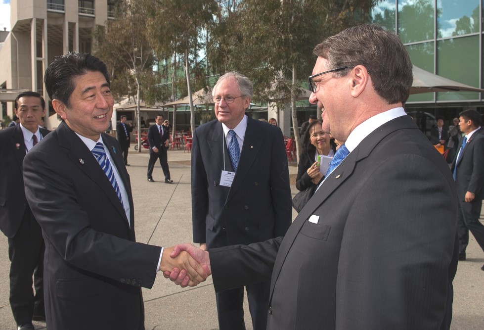 The Hon Warwick Smith, Chairman of Asia Society Australia greets Prime Minister Abe watched by Sir Rod Eddington, President AJBCC. (Irene Dowdy)
