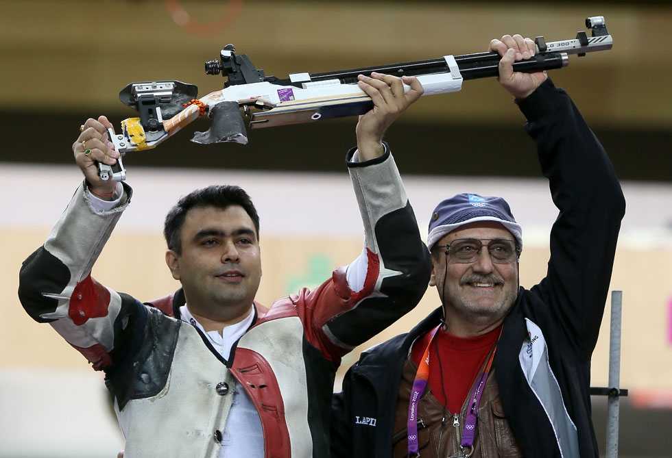 BRONZE: India's Gagan Narang (L) celebrates with his coach after winning the bronze medal in the Men's 10m Air Rifle final on July 30, 2012. (Marwan Naamani/AFP/GettyImages)