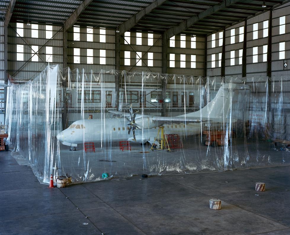 A plane waits to be painted in a hangar at Yangon International Airport. (Andrew Rowat)