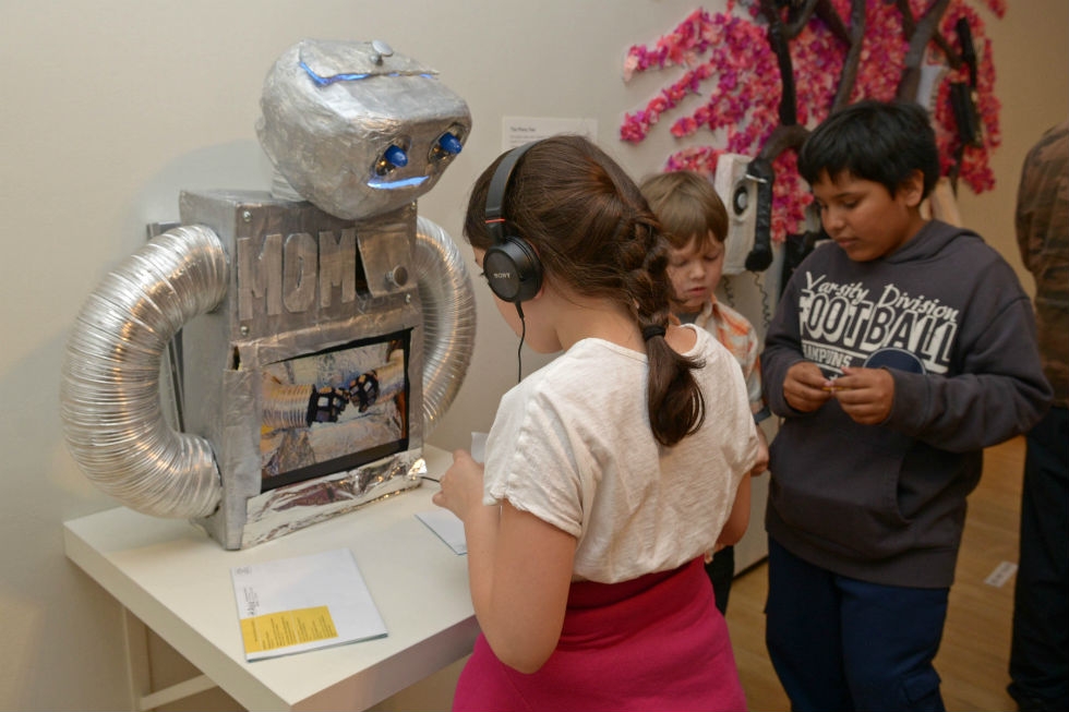Children test the functionality of the Metallic Origami Maker, or M.O.M. robot. (Elsa Ruiz)