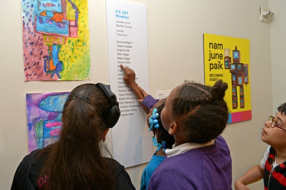 Student artists from P.S. 297 in Brooklyn find their names on the gallery wall. (Elsa Ruiz)