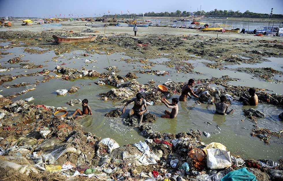 Indian men search for coins and gold in the polluted waters of the Ganga river at Sangam after the Kumbh Mela festival, in Allahabad on April 2, 2013. (Sanjay Kanojia/AFP/Getty Images)