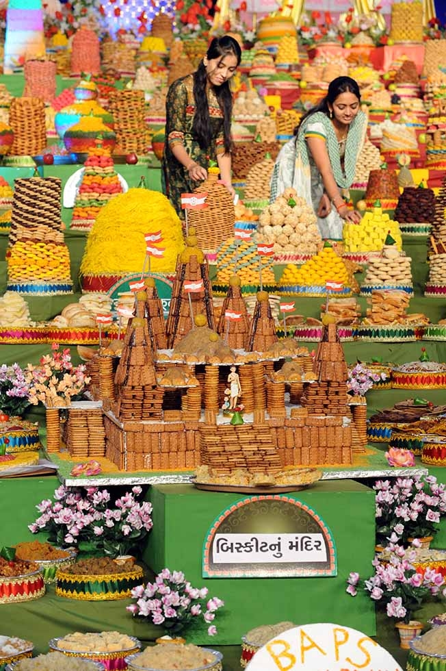 Hindu devotees place sweets at the display area for the Hindu celebrations of Maha Annakut Festival, the second day of Diwali celebrations in Gujarat, in Ahmedabad on October 27, 2011. The sweets donations by devotees are distributed to the population in rural areas of Indian state of Gujarat. (Sam Panthaky/AFP/Getty Images)