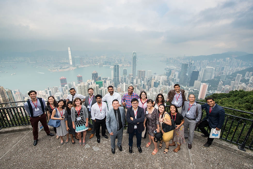Attendees of Asia Society's Asia 21 Summit pose in front of the Hong Kong skyline on December 2, 2015. The attending Asia 21 Young Leaders discussed various best practices in leadership and what new generations may do to create new opportunities for partnerships, sustainability, and cooperation. (Tahiat Mahboob/Asia Society)