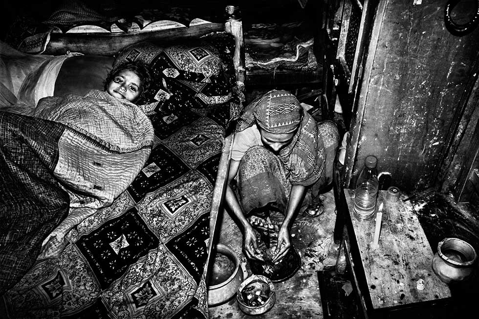 Hena prepares supper after nine hours at the factory in Dhaka. (Gazi Nafis Ahmed)