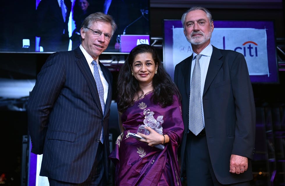 Adrian Keller (R) and Robert Niehaus (L) present Durreen Shahnaz with her Asia Game Changer Award at the United Nations on October 27, 2016. (Jamie Watts/Asia Society).