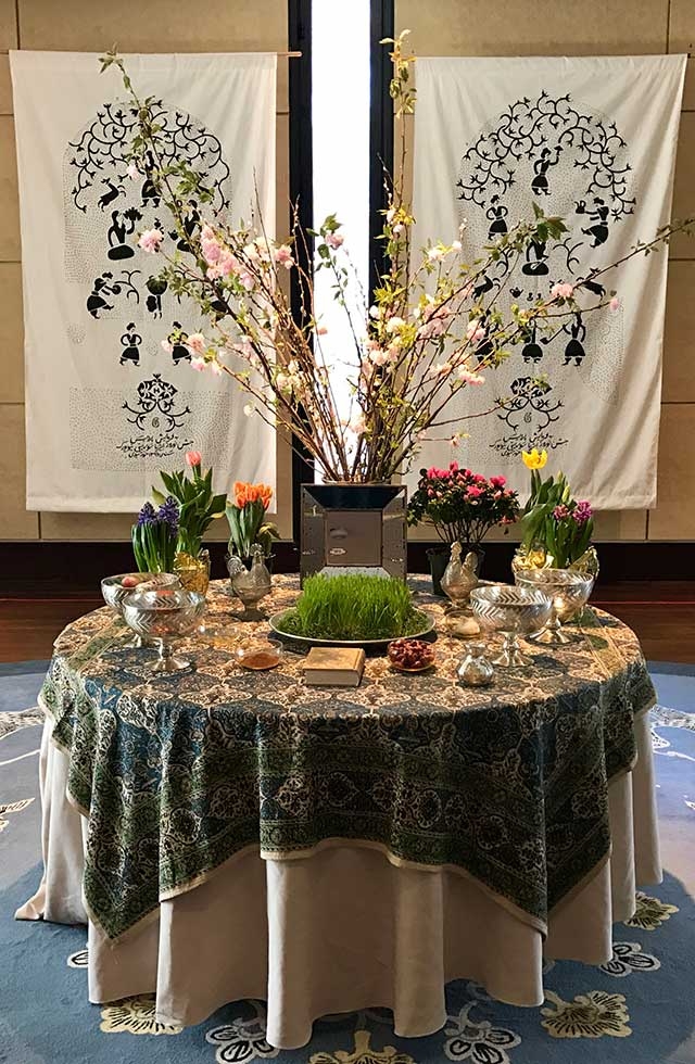 Celebrants put together a shared "Haft-Seen," a typical celebratory table spread, at Asia Society New york on March 18, 2017. (Ali Yousefian/Asia Society)