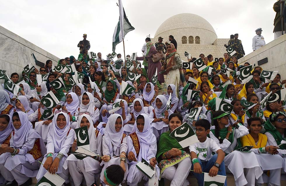 Pakistani students hold national flags during a ceremony at the mausoleum of Pakistan's founder Mohammad Ali Jinnah to mark the country's Independence Day in Karachi on August 14. (Asif Hassan/AFP/Getty) 