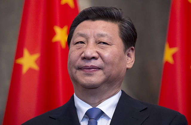 Chinese President Xi Jinping stands by national flags in Berlin on March 28, 2014. (Johannes Eisele/AFP/Getty)