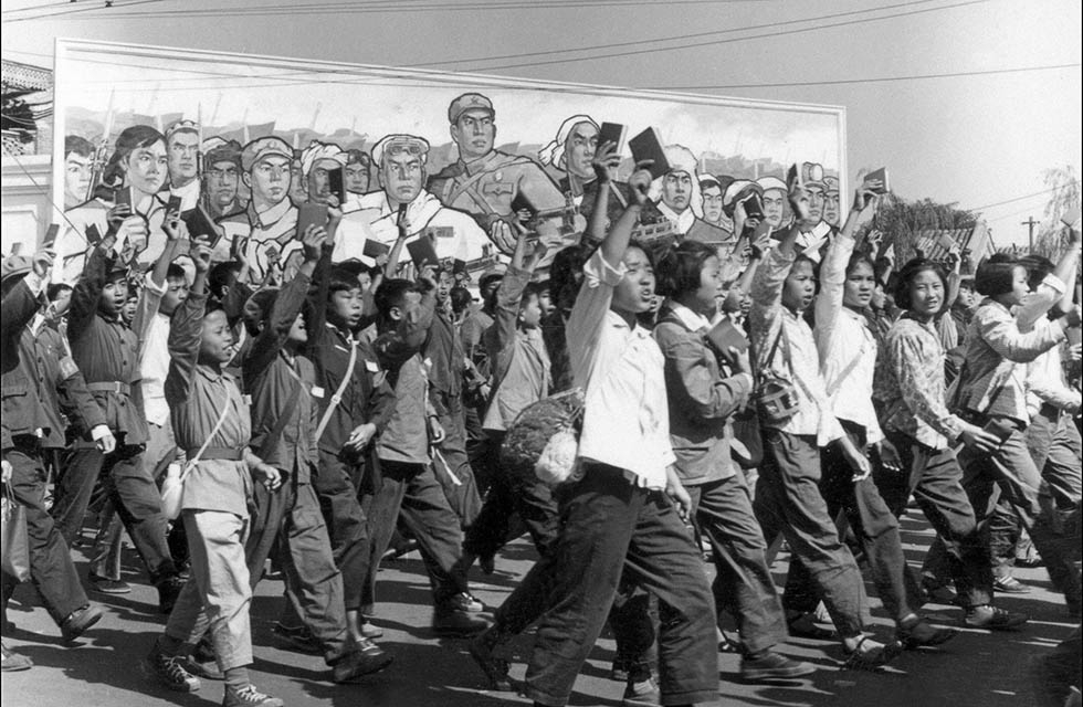 In June, 1966, Chinese Red Guards — high school and university students — wave copies of Chairman Mao Zedong's "Little Red Book" as they parade in Beijing's streets. (Jean Vincent/AFP/Getty Images)