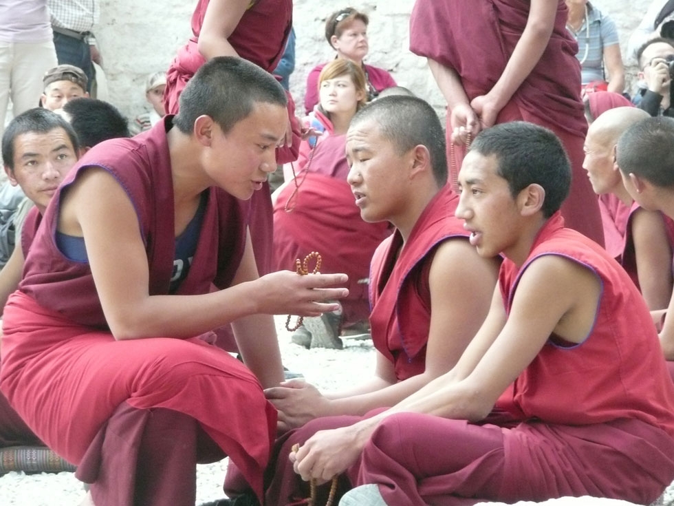 Young monks training one another in the "debating courtyard" at Sera Monastery. (Jessica Kehayes)