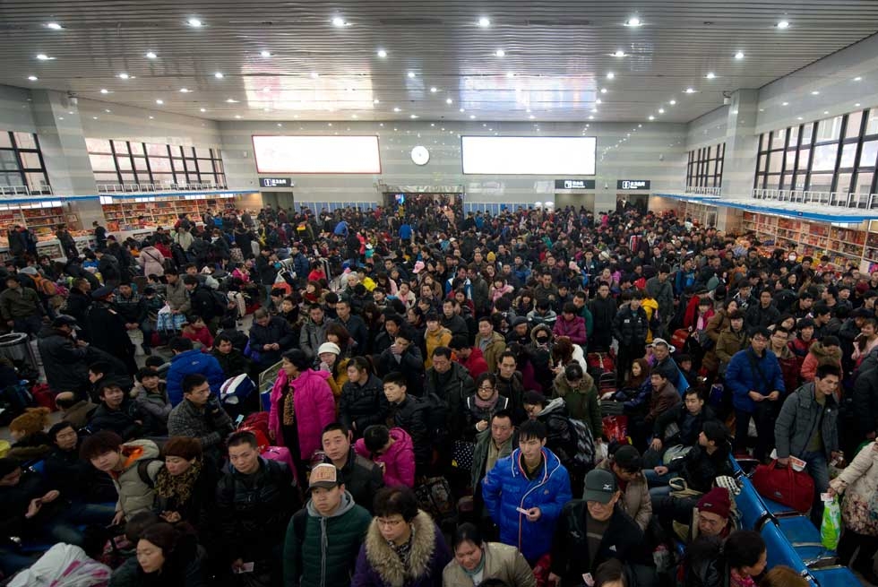 Lunar New Year travellers wait for their train at the West Railway Station in Beijing on January 31, 2013. (Ed Jones/AFP/Getty Images)