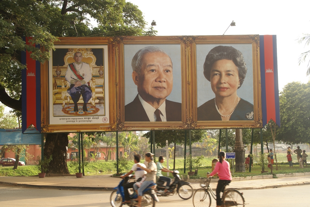 Cambodia's royal family is revered across the country with huge posters, as show in this photo taken in Siem Reap Province in November 2007. L to R: the current King Norodom Sihamoni, Norodom Sihanouk, and the Queen Mother. (Patrik M. Loeff/Flickr)
