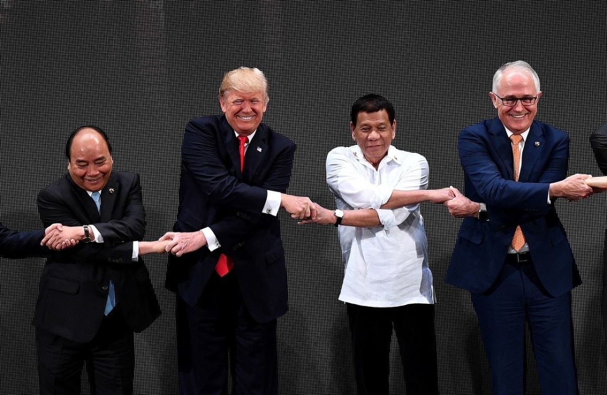 ASEAN members, including U.S. President Donald Trump, link hands during the opening ceremony of the 31st ASEAN Summit.