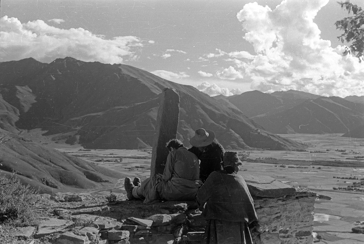 Tucci copying inscriptions from a stone pillar (rdo ring) at an unidentified location, possibly in U, Tibet. (Anonymous, 1948; Neg. dep. 8047/15. Courtesy of Istituto Italiano per l'Africa e l'Oriente (Is.I.A.O.) in l.c.a. and Ministero Degli Affari Esteri e della Cooperazione Internazionale.)