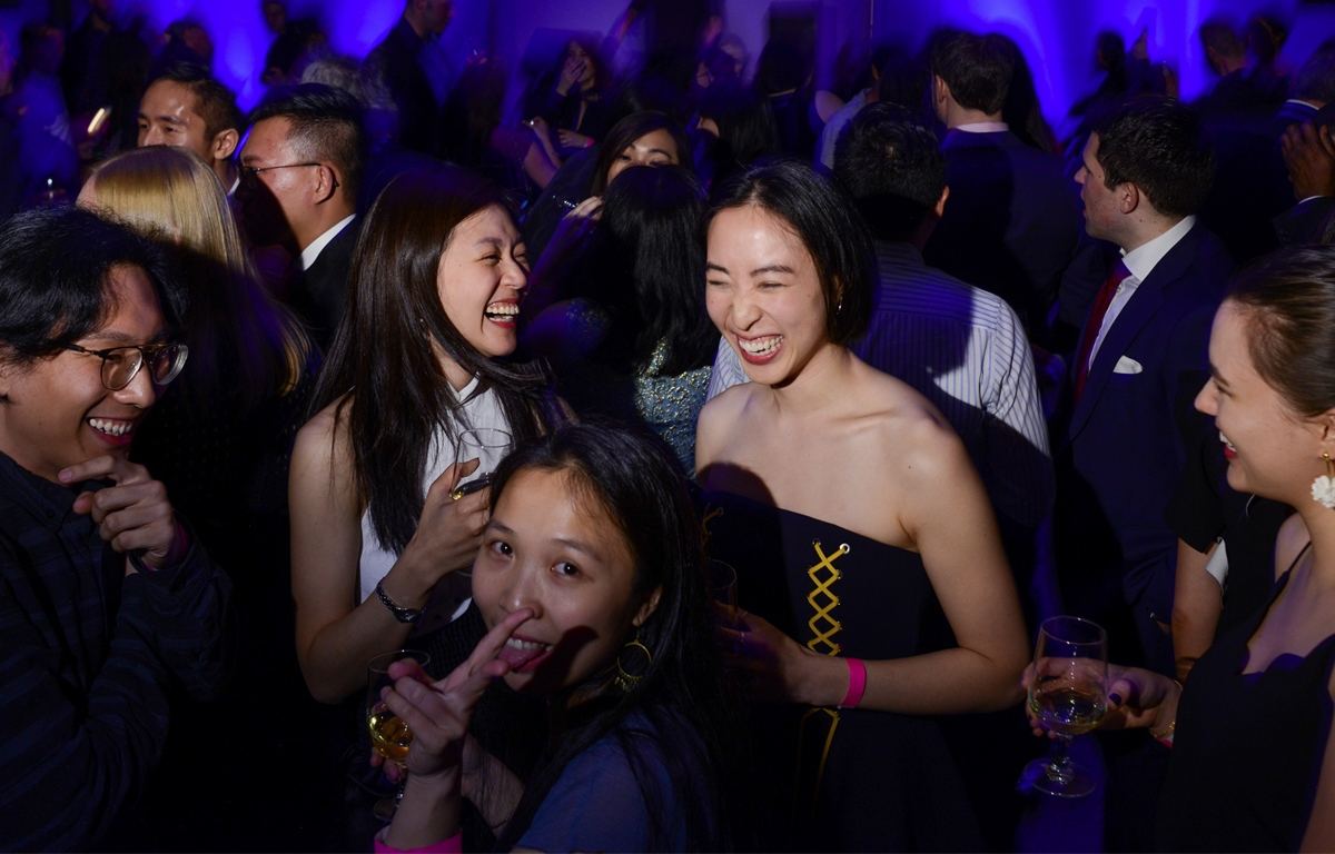 Guests share a laugh at an Asia Society party