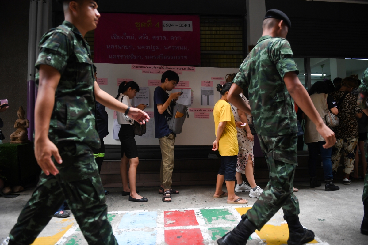 Thai soldiers queue up with others to cast their ballots during early voting in Bangkok on March 17, 2019, ahead of the March 24 general election.