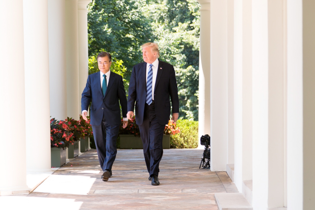 Presidents Moon Jae-in and Donald Trump walk together at the White House in June 2017