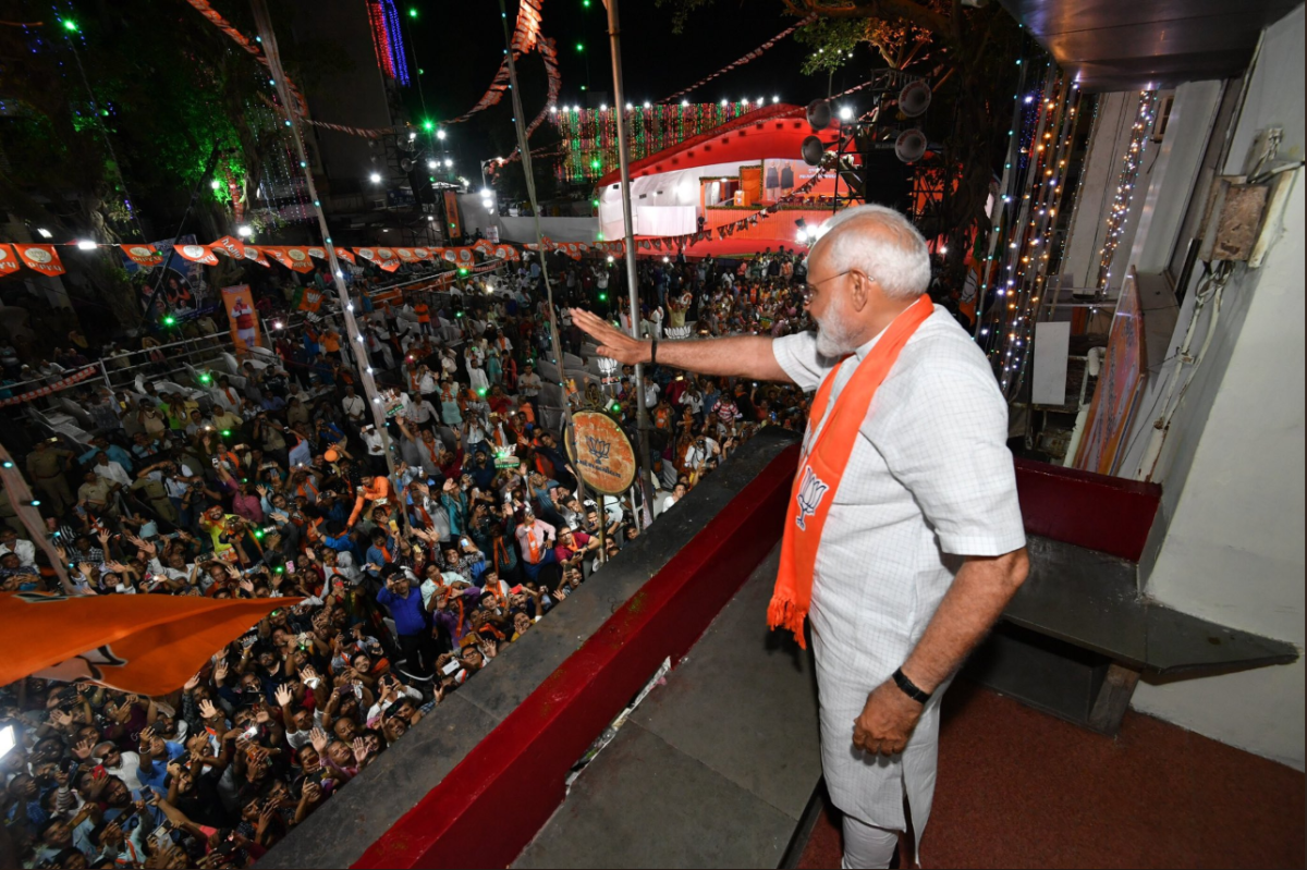 After his landslide win, Indian Prime Minister Narendra Modi waves to a group of supporters during his visit to Khanpur, Ahmedabad on May 26, 2019.