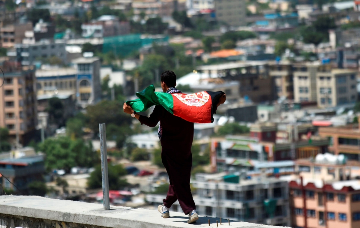 Man with flag celebrating Afghanistan's 100th anniversary of its independence