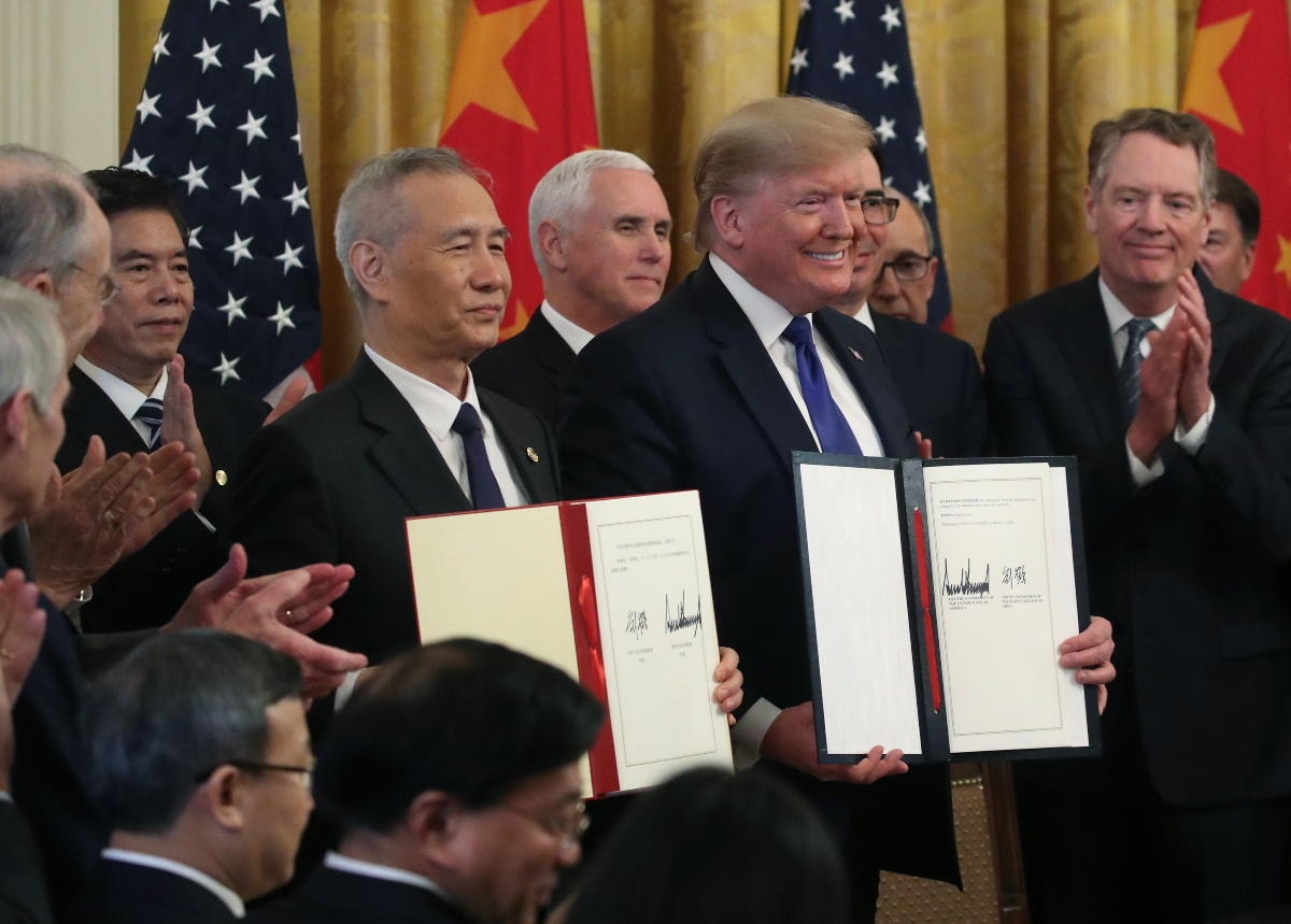 Liu He and Donald Trump hold up signed agreements of phase one of the U.S.-China trade deal