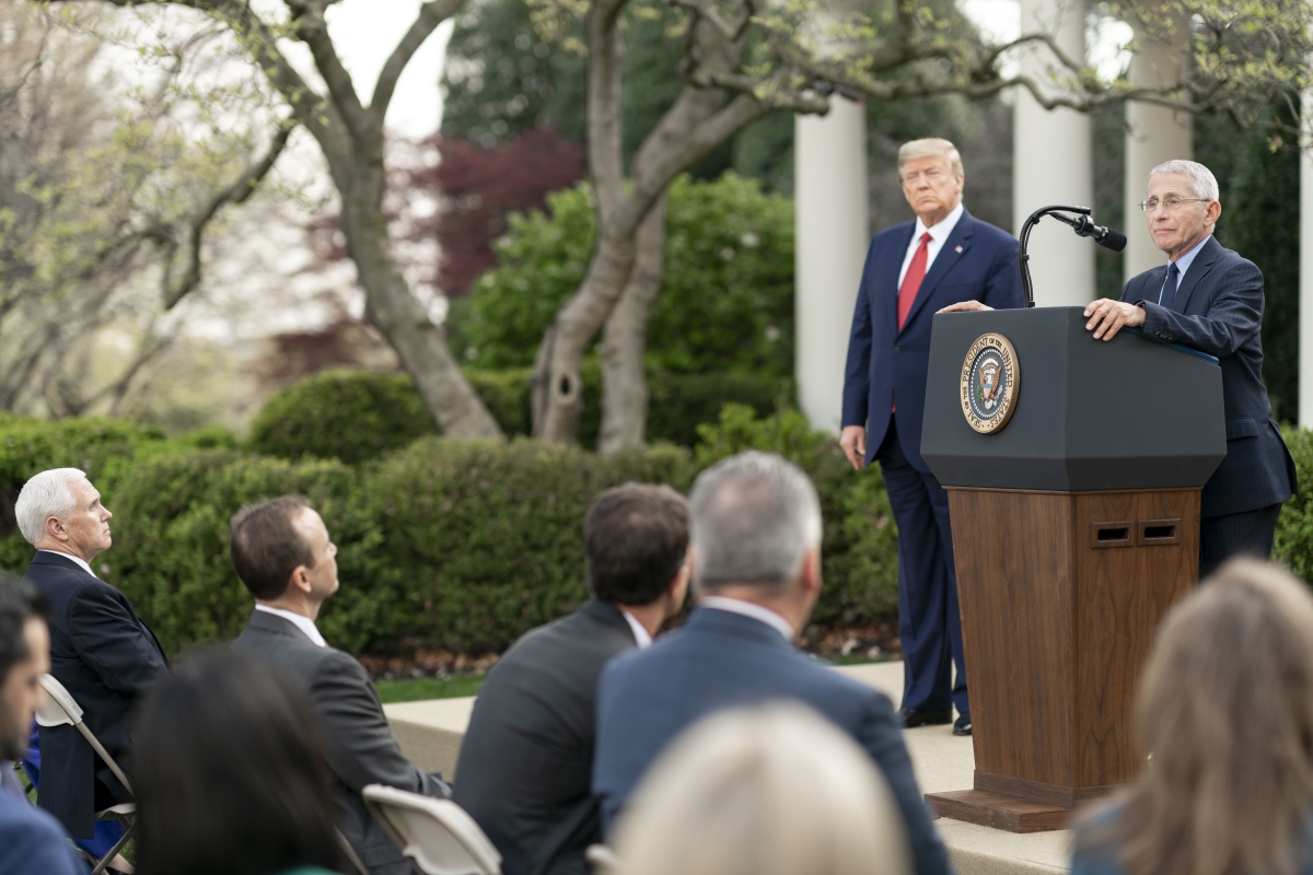 U.S. President Donald Trump listens as Director of the National Institute of Allergy and Infectious Diseases Dr. Anthony S. Fauci delivers remarks during a coronavirus update briefing Sunday, March 29, 2020, in the Rose Garden at the White House