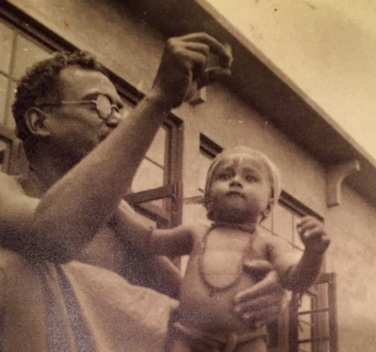 A photograph of young Supratik Bose in the arms of his grandfather, Nandalal Bose.