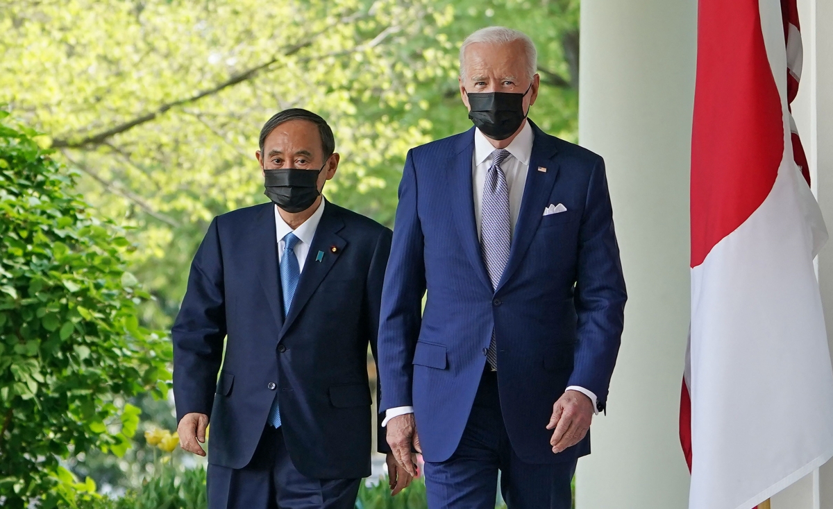 President Joe Biden and Japan's Prime Minister Yoshihide Suga walk through the Colonnade to take part in a joint press conference at the White House