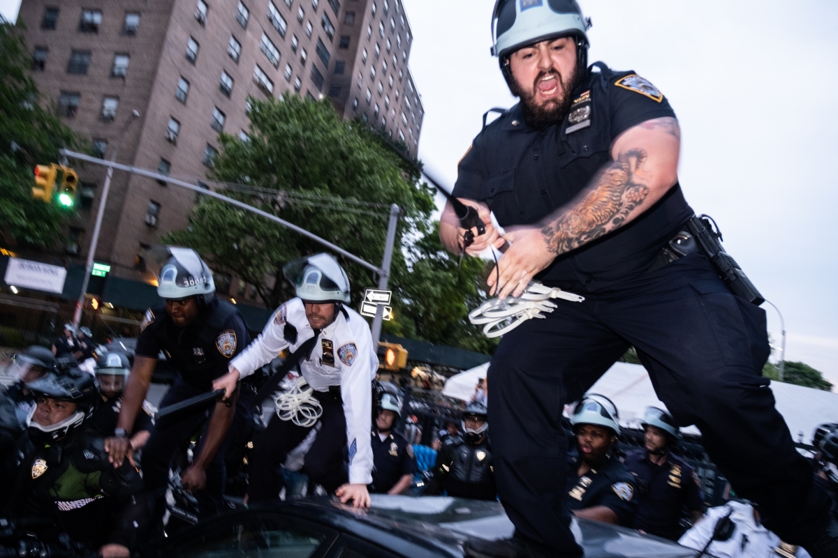  NYPD officers climb atop a car during protests in the South Bronx on June 4, 2020. 