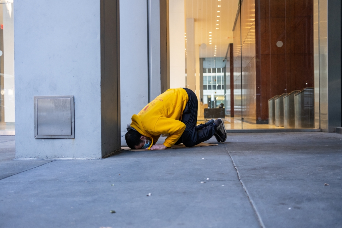 Azzedine Selmane prays in Midtown Manhattan on April 22, 2020, during a break from operating his Halal Guys food cart, which was frequented by essential workers during the height of the COVID-19 outbreak in New York City.