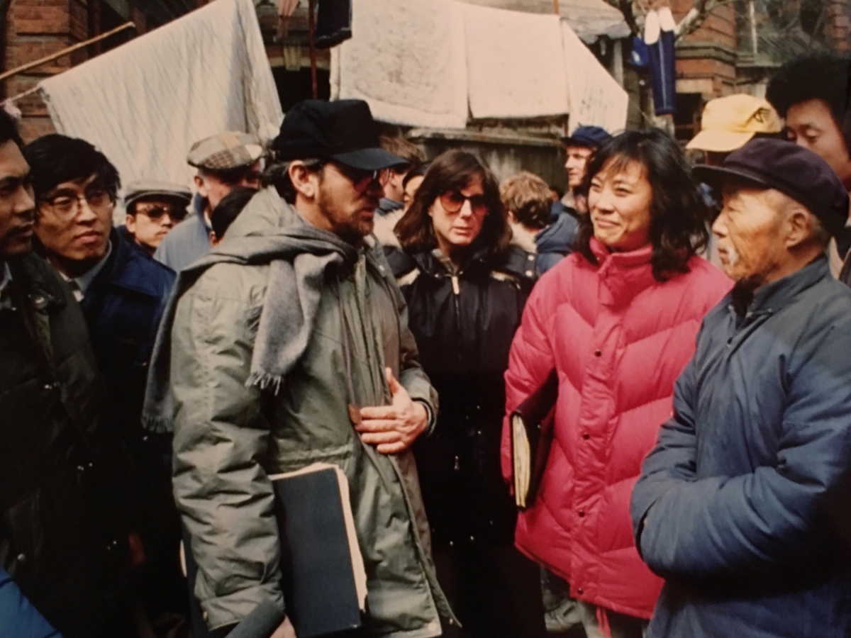 Janet Yang, second from right, talks with director Steven Spielberg, center, on the set of his 1986 film 'Empire of the Sun,' filmed in Shanghai, China.