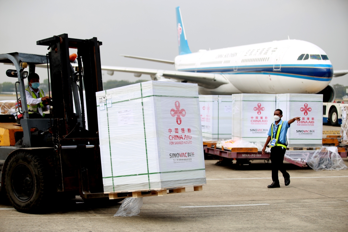 A staff member transfers China-donated COVID-19 vaccines at Yangon International Airport in Yangon, Myanmar, Dec. 22, 2021. A new batch of Sinovac COVID-19 vaccines donated by China arrived in Myanmar's Yangon on Wednesday.