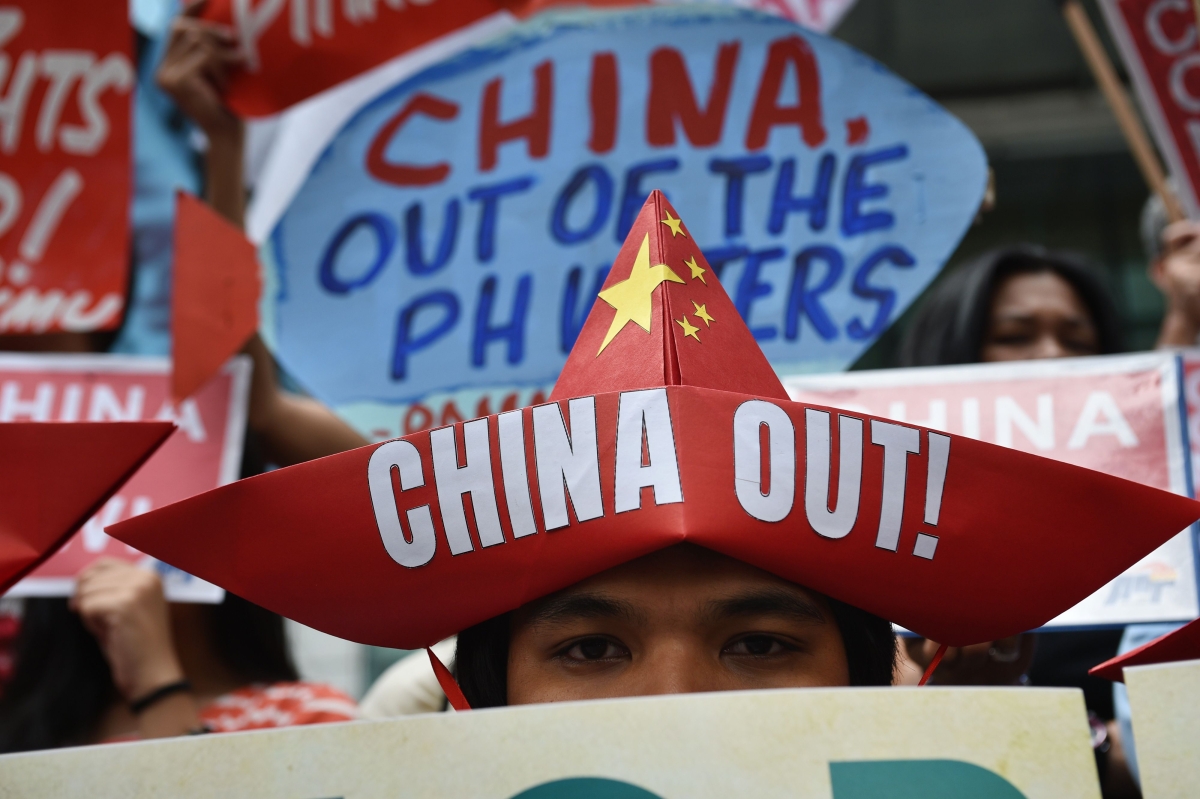 Activists holding placards hold a protest in front of the Chinese consulate in Manila on February 10, 2018, against Beijing's claims in the South China Sea after installing military facilities and equipment on them. 