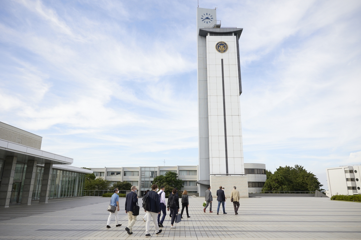 The group walking past the Tower and Information and Media Library at National Defense Academy, Yokosuka