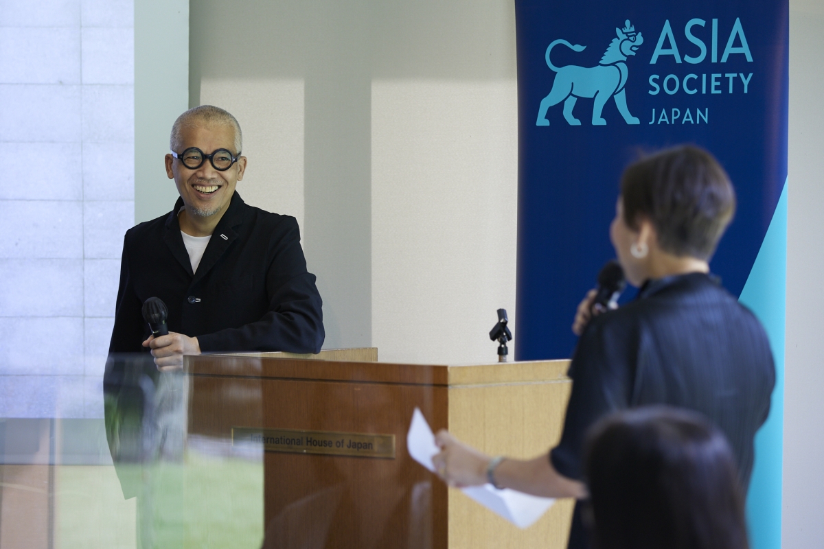Mr. Wong smiling while listening to a comment from Asia Society Japan director, Sawako Hidaka