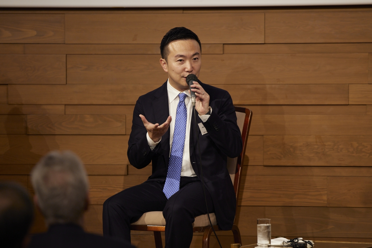 Hironobu Akiyama (Stephen Chan) speaking to the audience