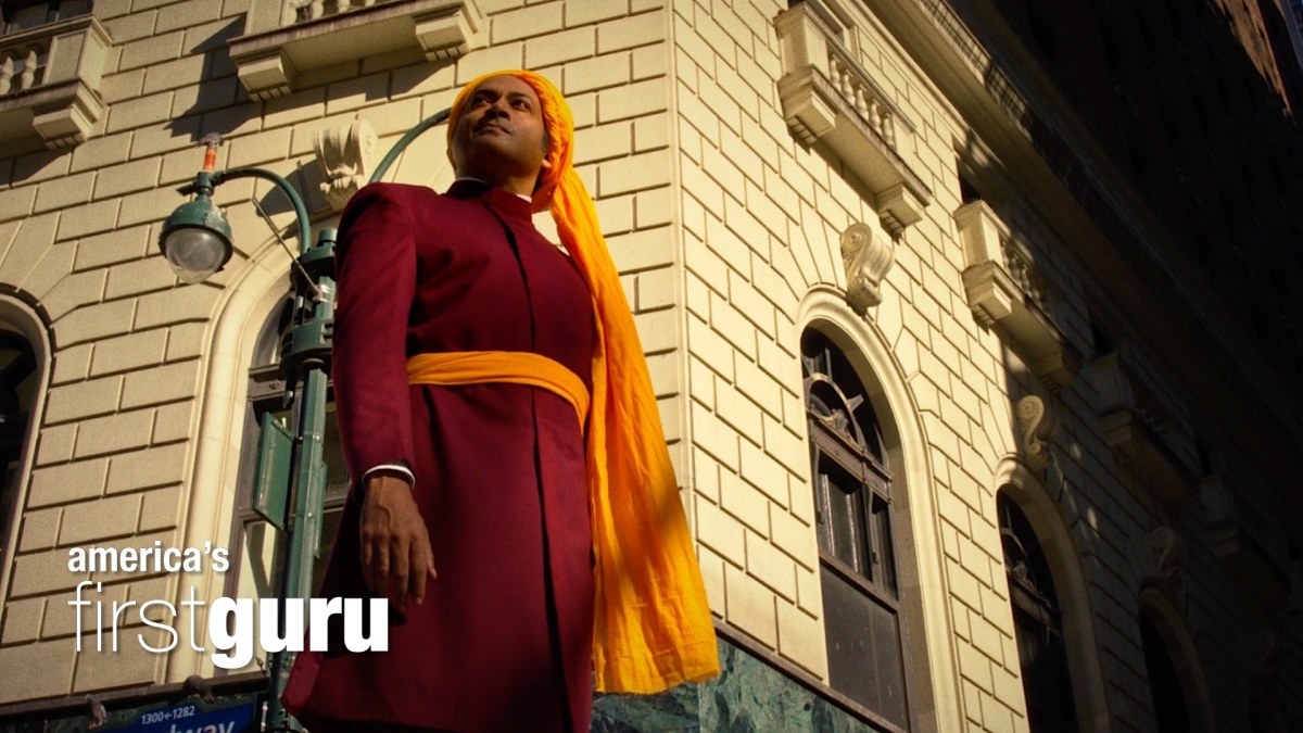 an image of swami vivekananda standing against a building in New York