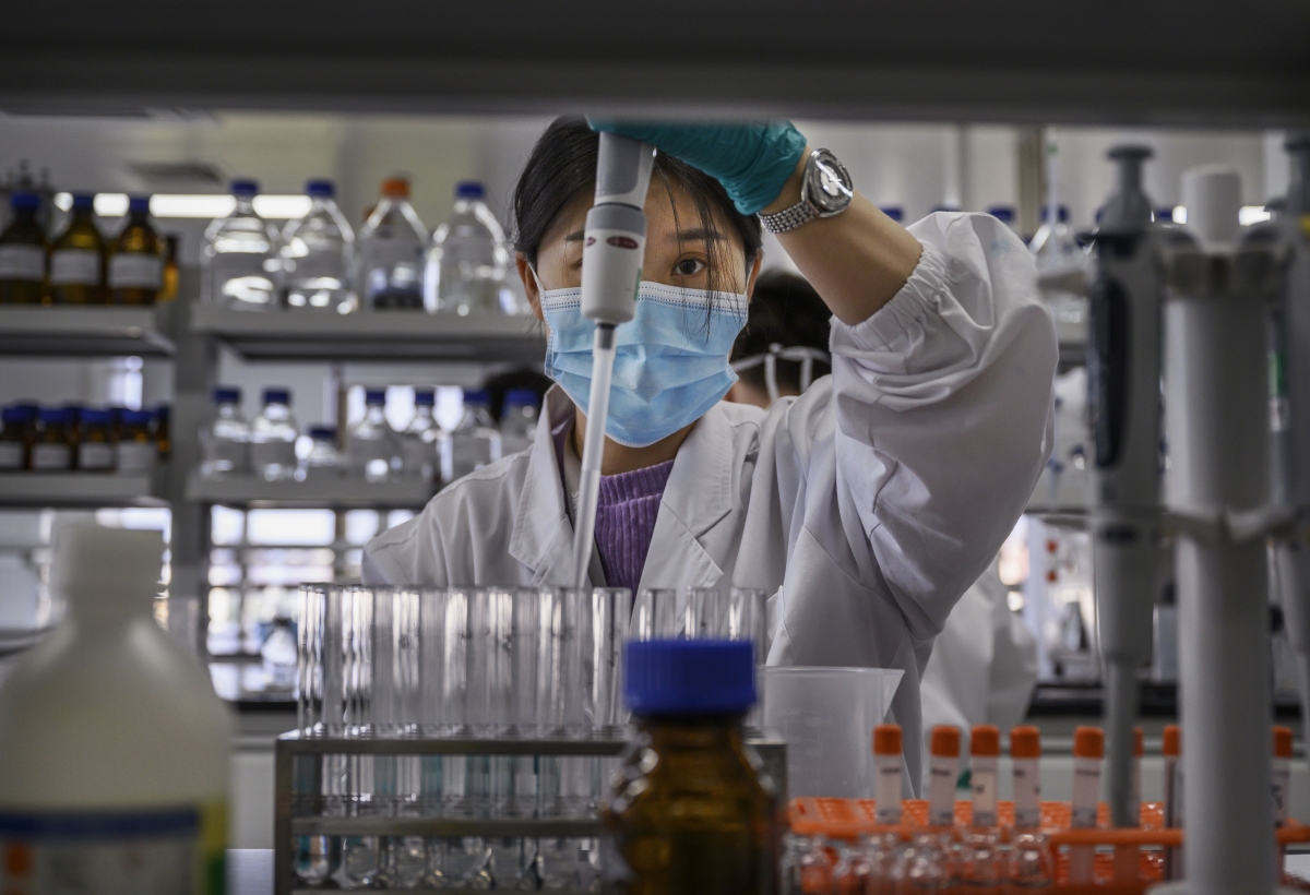 A technician works in a lab at Sinovac Biotech