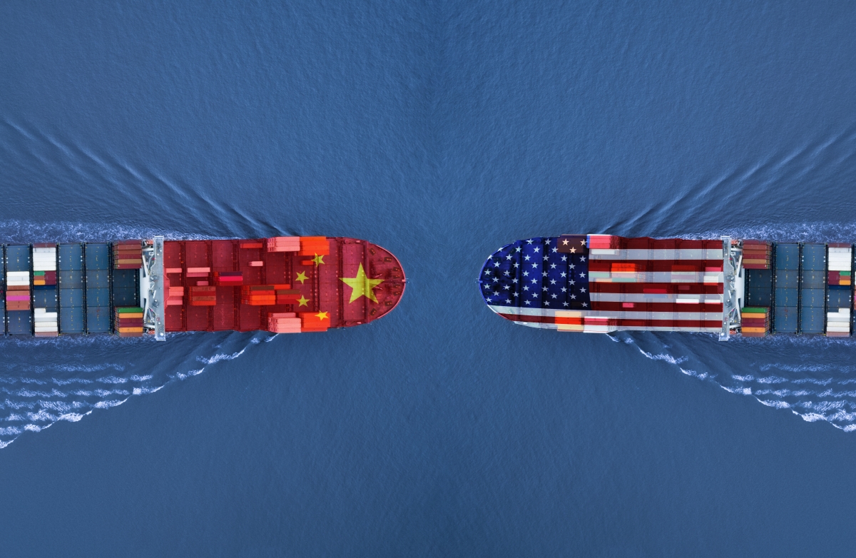 A photo depicting two container ships on a collision course, one with the Chinese flag and the other with the American flag superimposed.