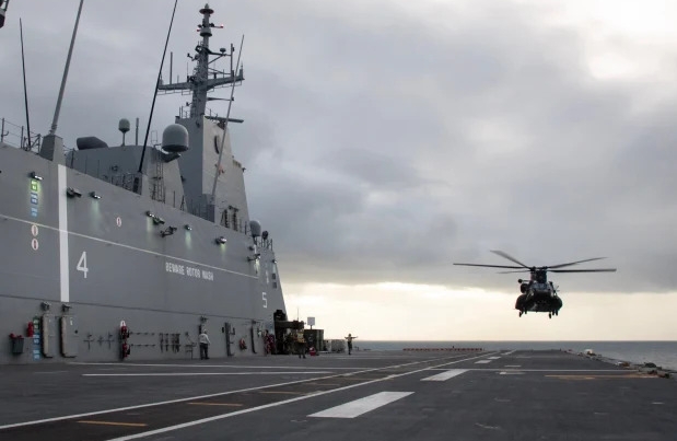 A United States Army MH-47G Chinook helicopter from 160th Special Operations Aviation Regiment prepares to land on the Royal Australian Navy ship HMAS Adelaide during Exercise Balance Action in 2023.