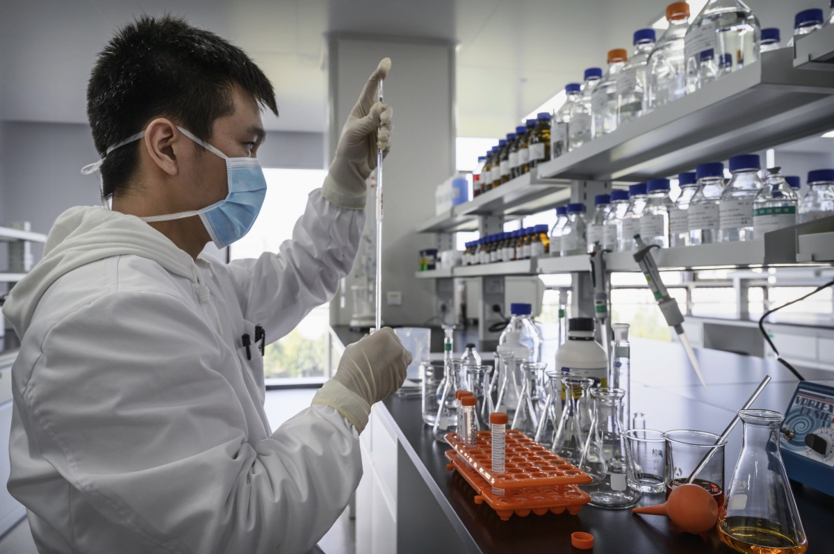 A technician works in a lab at Sinovac Biotech