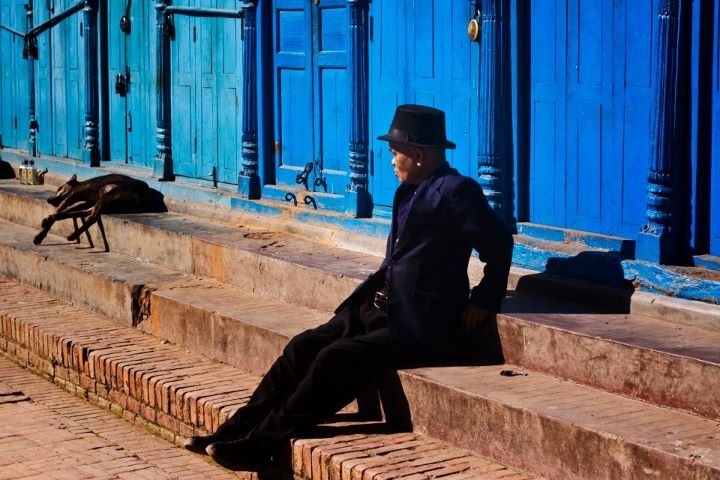 A man rests on the steps in Patan. (Sai Abishek)