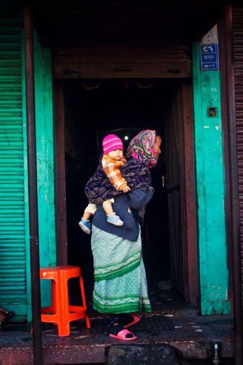 A woman carries a child in Old Pokhara. (Sai Abishek)