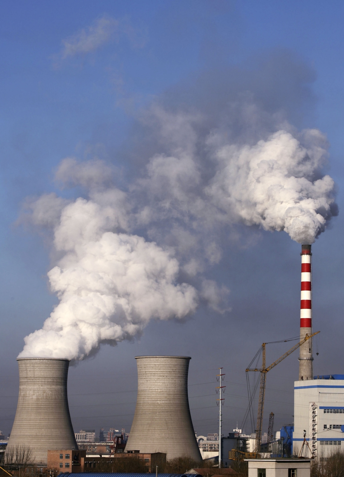 CHIFENG, MONGOLIA - Smoke billows from chimneys at the Chifeng Thermal Power Plant on February 23, 2007 in Chifeng, Mongolia. (China Photos/Getty Images) 