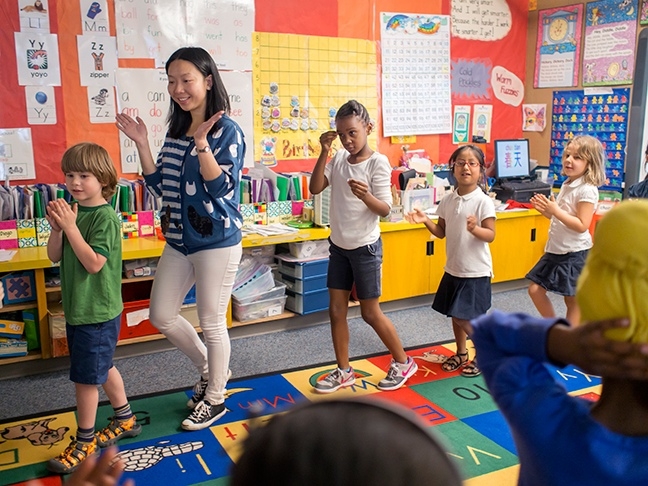 Visiting teacher from Chongqing engages kindergardeners in song and movement as they learn Chinese language at Beacon Hill International School. 