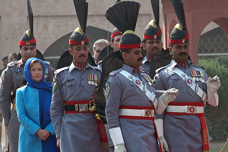 US Secretary of State Hillary Clinton (2nd L in blue) is escorted by Pakistan Rangers as she arrives at the tomb of Pakistan's national poet Allama Mohammad Iqbal during her visit to Lahore on October 29, 2009. (STR/AFP/Getty Images)