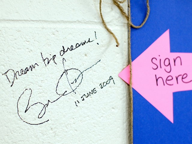 President Obama wrote "Dream big dreams!" on a school wall in Wisconsin.
