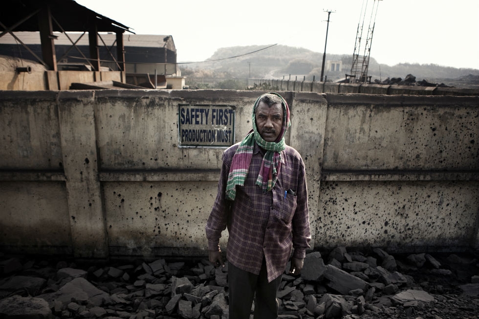 A miner at the entry of a state-owned mine in Jharia. (Note the sign.) (Erik Messori)